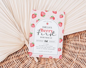May include: Pink and white birthday invitation with a strawberry pattern. The invitation says "Join us for Amelia's Berry First Birthday" with the date "Saturday 14 August" and the time "at 11:30am". The location is "The Stables Farm & Estate 1178 N Willow Lane, Galena, IL 61036". RSVP to Courtney 000 000 0000.  Registered at Target.