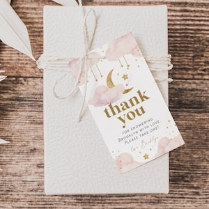 May include: A white gift box with a brown twine bow and a pink and gold thank you tag with the text "Thank you for showering Brooklyn with love. Please take one!" and the name "Love, Bailey".
