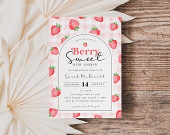 May include: A pink and white gingham baby shower invitation with a strawberry pattern. The text reads "Join us for a Berry Sweet Baby Shower in celebration of Mama-to-be Sarah McDonald, Saturday, August 14 at 11:30am. The Stables Farm & Estate, 1756 N Willow Lane, Galena, IL 48675. RSVP by to Courtney 000.000.0000. Registered at Target."