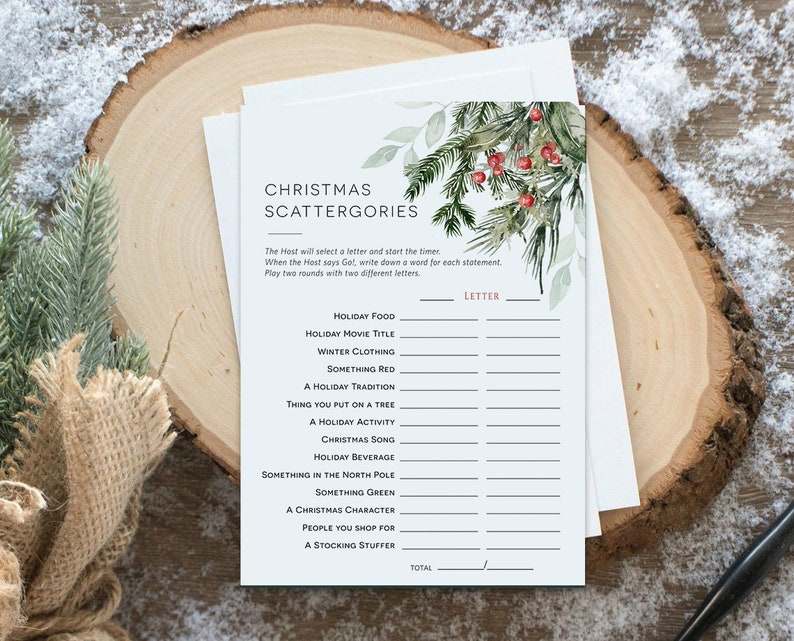 May include: A printable Christmas Scattergories game with a watercolor illustration of a green pine branch with red berries. The game includes categories like Holiday Food, Holiday Movie Title, Winter Clothing, Something Red, A Holiday Tradition, Thing You Put on a Tree, A Holiday Activity, Christmas Song, Holiday Beverage, Something in the North Pole, Something Green, A Christmas Character, People You Shop For, and A Stocking Stuffer.