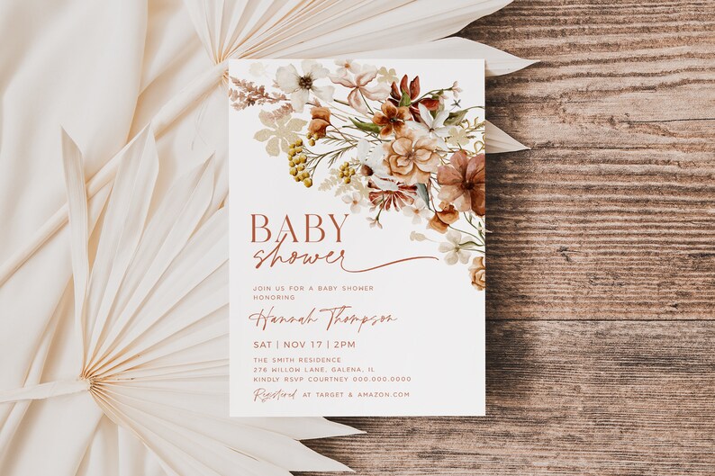 May include: A white baby shower invitation with a floral design in shades of brown, orange, and yellow. The text reads "BABY shower" in brown lettering and "JOIN US FOR A BABY SHOWER HONORING Hannah Thompson SAT NOV 17 2PM THE SMITH RESIDENCE 276 WILLOW LANE, GALENA, IL KINDLY RSVP COURTNEY 000 000 0000 Rfid AT TARGET & AMAZON.COM".
