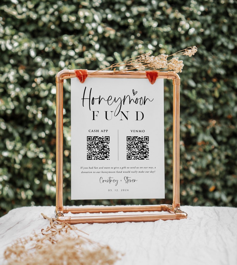 May include: A white sign with black text and QR codes for a honeymoon fund. The sign reads "Honeymoon Fund", "Cash App", "Venmo", and "If you had fun and want to give a gift to send us on our way, a donation to our honeymoon fund would really make our day!" The sign is also signed "Courtney & Steven" and "05.12.202x".