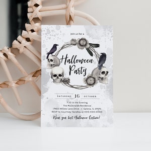 May include: A black and white Halloween party invitation with a wreath of skulls, roses, and crows. The text reads "Join us for a Halloween Party" and includes the date, time, location, and RSVP information.