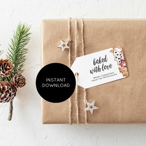 May include: A white gift tag with the text "baked with love" and "Merry Christmas from the McDonalds" printed on it. The tag is tied with twine to a brown paper gift box with a star-shaped ornament.