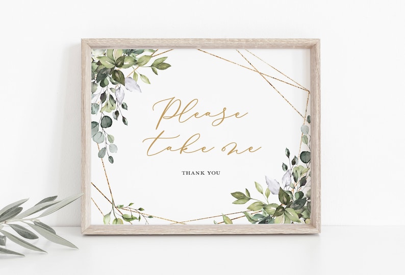 May include: A framed sign with the text "Please take one" in gold script. The sign is decorated with watercolor greenery and gold geometric accents. The frame is a light wood color, and the overall design is elegant and suitable for weddings or events.