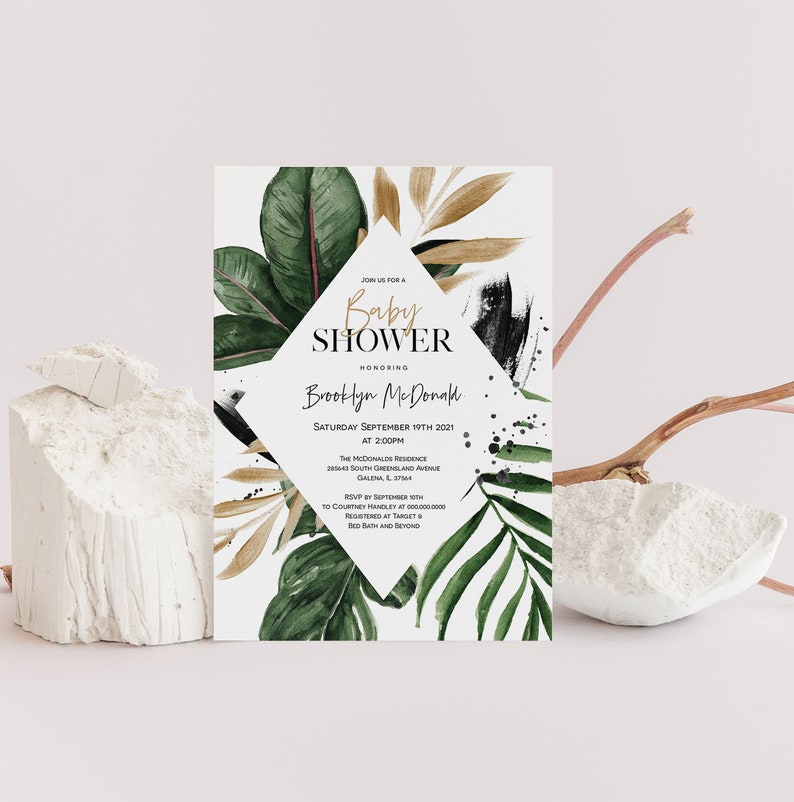 May include: A white baby shower invitation with a gold geometric shape and green and brown watercolor tropical leaves. The text reads "Join us for a Baby Shower Honoring Brooklyn McDonald Saturday September 19th 2021 at 2:00PM The McDonald Residence 28143 South Greenland Avenue Galena, IL 3784 RSVP by September 19th to Courtney Handley at 0000000000 Registered at Target & Bed Bath and Beyond"