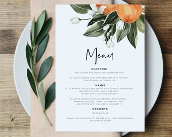 May include: A menu card with a watercolor design of oranges and green leaves. The word "Menu" is written in elegant script. The menu lists starters, mains, and desserts, including goat cheese tart, filet mignon, and wedding cake.