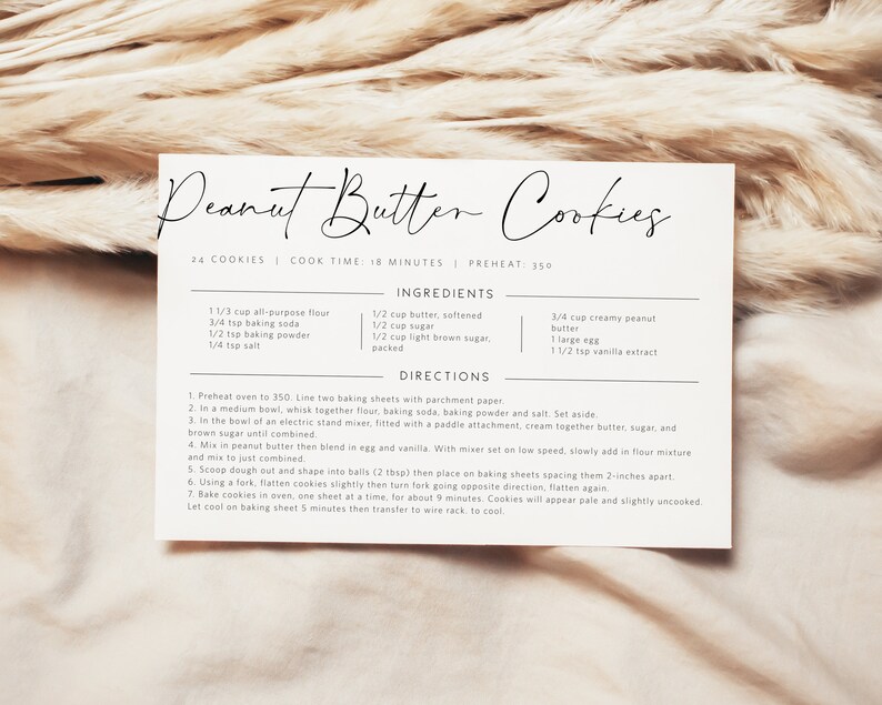 May include: A printable recipe card for peanut butter cookies. The recipe card is white with black text and includes a list of ingredients and directions for making the cookies. The recipe makes 24 cookies and has a cook time of 18 minutes. The oven temperature is 350 degrees Fahrenheit.