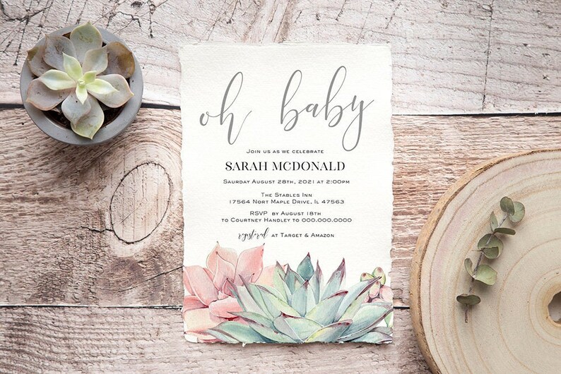 May include: Baby shower invitation with the words "oh baby" in elegant script. The invitation includes event details and watercolor succulents in shades of pink and green. The invitation is on textured paper.