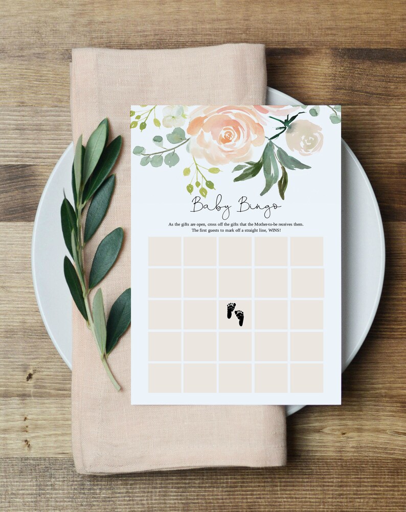 May include: A printable baby bingo card with a floral design. The card has a grid of squares with a footprint in one of the squares. The text on the card reads "Baby Bingo" and "As the gifts are open, cross off the gifts that the Mother-to-be receives them. The first guest to mark off a straight line, WINS!"