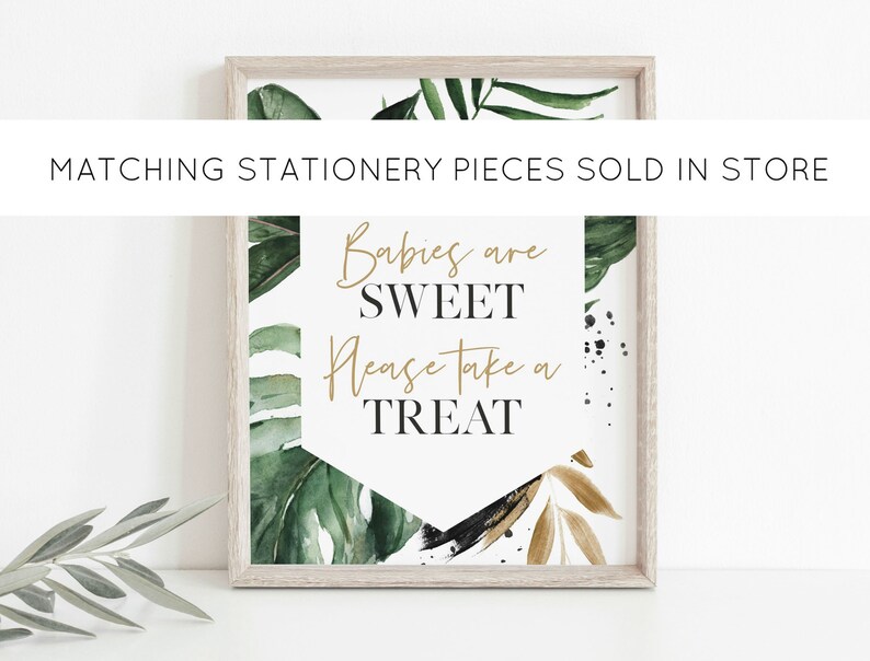 May include: A framed print with a tropical leaf design and the text "Babies are sweet, please take a treat".