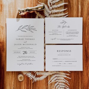May include: A wedding invitation suite with a white background and black text. The invitation features a simple floral design and the names Sarah Thomas and Jason McDonald. The details card includes information about the reception, accommodation, and RSVP details. The response card includes a section for guests to indicate their attendance and dietary requirements.