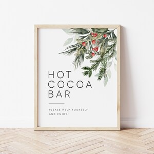 May include: A printable sign with a watercolour illustration of pine branches and red berries. The sign reads "Hot Cocoa Bar" and "Please help yourself and enjoy!"