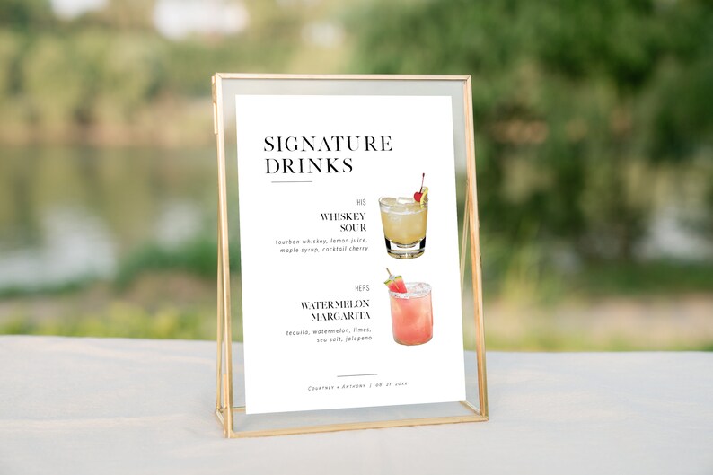 May include: A white sign with black text that reads "SIGNATURE DRINKS" and lists two cocktails: "Whiskey Sour" and "Watermelon Margarita".  Each cocktail is illustrated with a drawing of a glass with a cherry and a slice of watermelon.