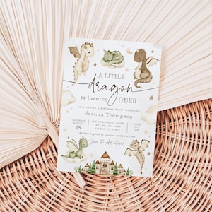 May include: A white invitation with a watercolor illustration of three green and brown dragons. The text reads "A Little Dragon is turning ONE!" and includes details for a birthday party honoring Joshua Thompson.