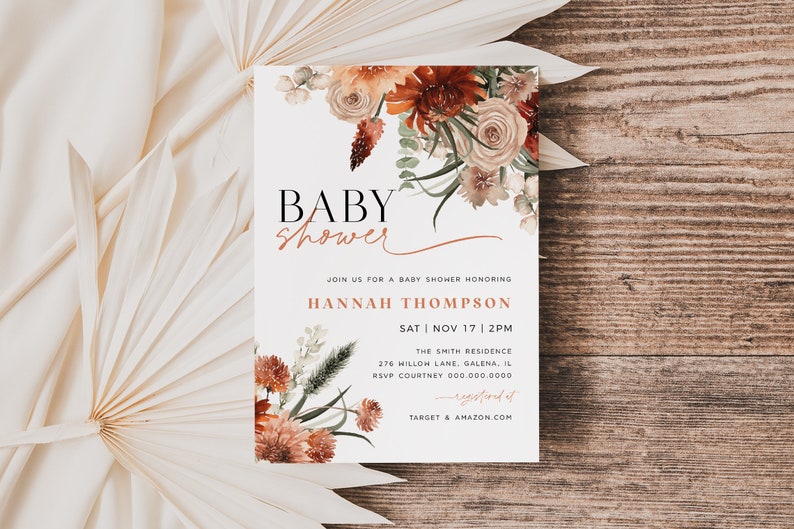 May include: A white baby shower invitation with a floral design in shades of orange, red, and brown. The text reads "BABY shower" in black and "JOIN US FOR A BABY SHOWER HONORING HANNAH THOMPSON SAT | NOV 17 | 2PM THE SMITH RESIDENCE 276 HILLOW LANE, GALENA, IL RSVP COURTNEY 000.000.0000 registered at TARGET & AMAZON.COM"