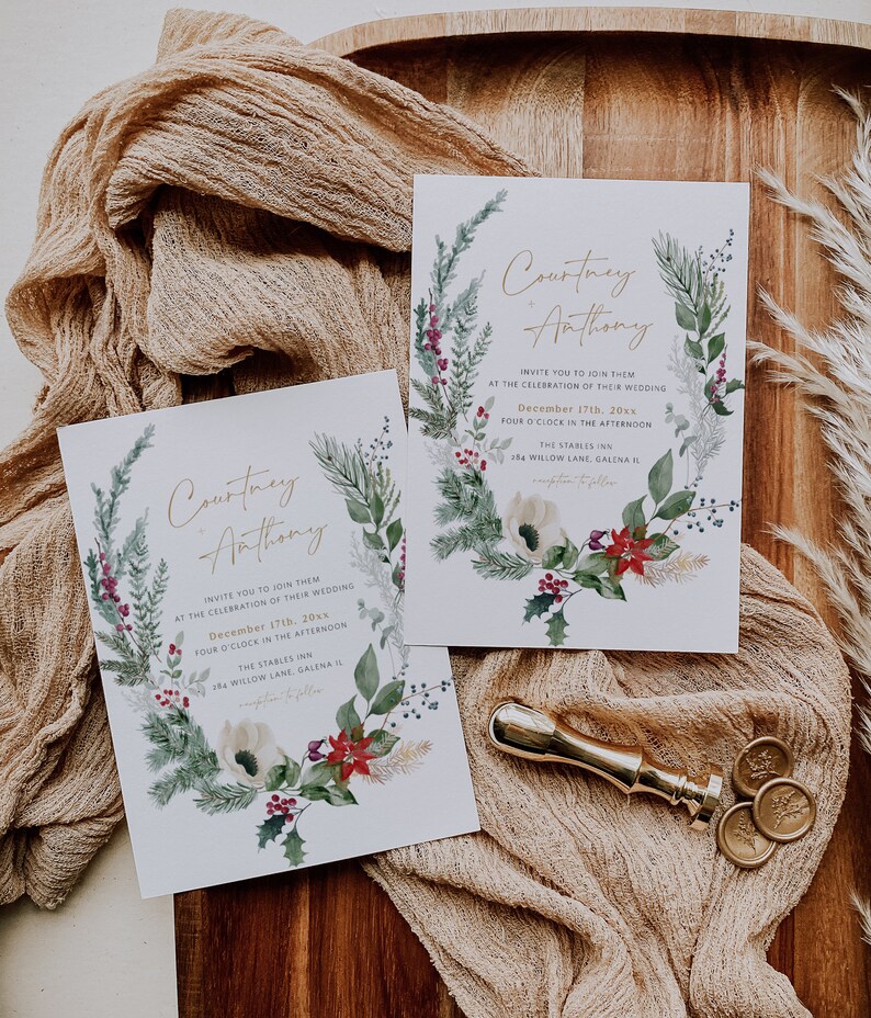 May include: A wedding invitation with a watercolor wreath of greenery, berries, and flowers. The invitation is for Courtney and Anthony's wedding on December 17th at The Stables Inn in Galena, Illinois.