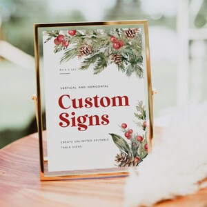 May include: A gold-framed sign with a watercolor illustration of pine branches, red berries, and pine cones. The sign reads "Custom Signs" and "Create Unlimited Editable Table Signs".