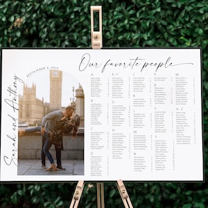 May include: A white wedding seating chart with a black border and the text "Our favorite people" in a cursive font. The chart lists guests alphabetically by last name. A photo of a couple kissing in front of Big Ben in London is in the upper left corner. The text "September 4, 2023" and "Sarah and Anthony" are also included in the photo.