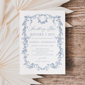May include: A white invitation with blue floral border and text that reads "Something Blue Before I Do!" Join us for a bridal shower honoring Sophia Anderson. Saturday, August 1st at 1:00pm. The Starless Lodge 1714 W Forest Road, Salem, IL 62881 RSVP by August 1st to Caroline Hadley at 555-555-5555. Registered at Target & Amazon.com