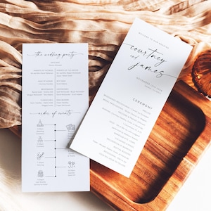 May include: Two white wedding programs with black text, one with "Courtney and James" and the date, the other with "The Wedding Party" and an order of events. The programs are on a wooden tray.