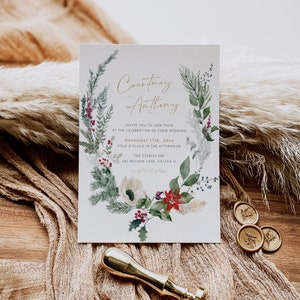May include: A wedding invitation with a watercolor illustration of a winter floral wreath. The invitation is for Courtney and Anthony's wedding on December 17th, 20xx at The Stables Inn in Galena, Illinois.