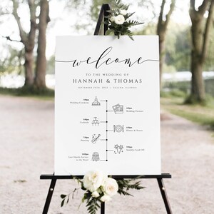 May include: A white wedding welcome sign with black calligraphy text that reads "Welcome to the wedding of Hannah & Thomas September 24th, 2022 Galena, Illinois". The sign also includes a timeline of wedding events with icons and times.