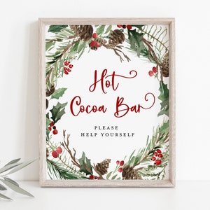 May include: A printable sign with a watercolor wreath of pine branches, holly, and red berries. The sign says "Hot Cocoa Bar" with the text "Please Help Yourself" below.