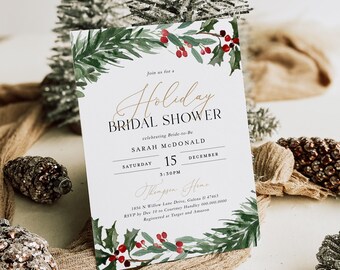 May include: A white card with a watercolor illustration of holly and berries. The text on the card reads "Join us for a Holiday Bridal Shower celebrating Bride-to-Be Sarah McDonald Saturday 15 December 3:30PM Thompson Home 1856 N Willow Lane Drive, Galena II 47463 RSVP by Dec 10 to Courtney Handles 000.000.0000 Registered at Target and Amazon"