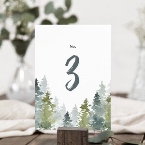 May include: A white card with a watercolor illustration of a forest with green and blue trees. The card has the text "No. 3" printed on it.