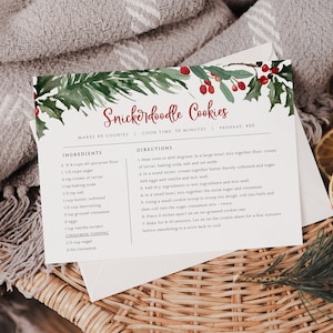 May include: A printable recipe card with a watercolor illustration of holly and berries. The recipe is for Snickerdoodle Cookies, and includes ingredients and directions. The card is on a woven basket with dried orange slices.