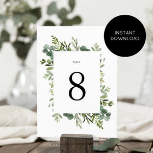 May include: A printable wedding table number card with a green watercolor floral border and the text "Table 8" in black.