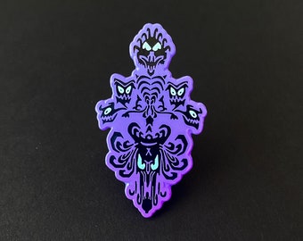 May include: Purple enamel pin featuring the Haunted Mansion's iconic wallpaper pattern with black silhouettes of ghosts.