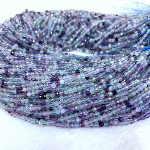 May include: A strand of faceted amethyst and aquamarine beads. The beads are a mix of light blue and purple shades. The beads are approximately 4mm in size.