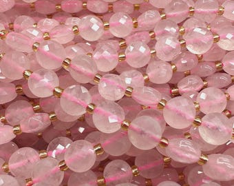 May include: Close-up of strands of pink rose quartz beads. The beads are a soft pink colour, with a faceted cut that catches the light. Each bead is separated by a small gold-coloured spacer. The beads are strung on a pink cord, creating a delicate and feminine look.
