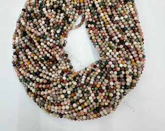 May include: A strand of multi-colored gemstone beads. The beads are small and round, with a faceted finish. The colors include pink, green, brown, and white.