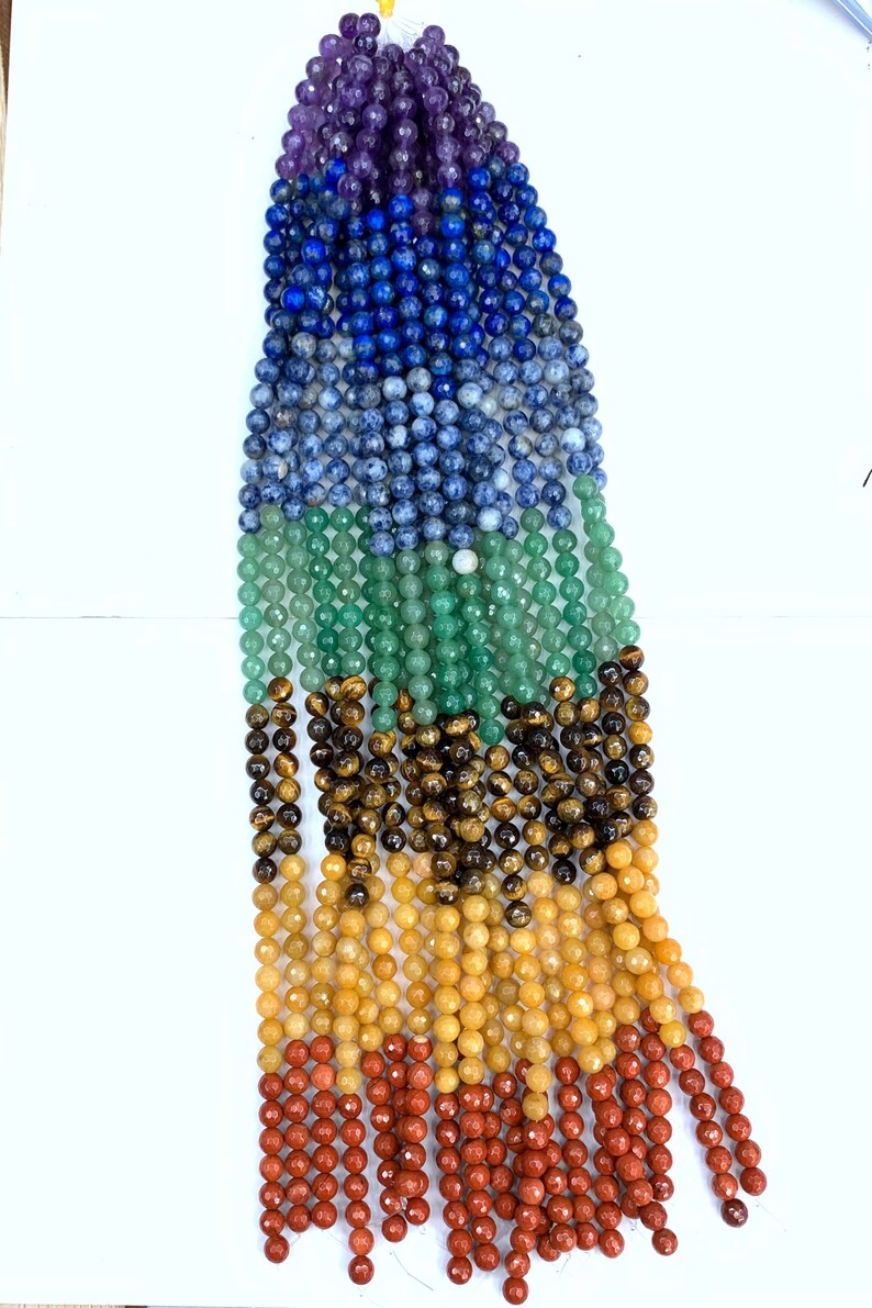 May include: A strand of gemstone beads in seven colors, including amethyst, lapis lazuli, sodalite, aventurine, tiger's eye, citrine, and red jasper.