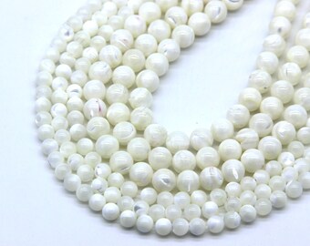 May include: A strand of white round shell beads with a pearlescent finish. The beads are strung on a white cord.