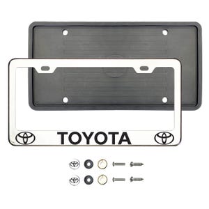 May include: A silver license plate frame with the word "TOYOTA" in black, along with the Toyota logo on each side. Includes a black rubber backing and mounting hardware. The frame is designed to fit a standard U.S. license plate.