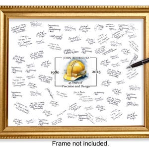 May include: A framed print with a gold-colored frame, filled with handwritten messages. The center features a yellow hard hat graphic, the name "JOHN RODRIGUEZ", and the text "45 Years of Precision and Design". A black pen rests on the frame.
