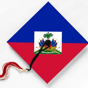 May include: A graduation cap featuring the flag of Haiti. The cap is divided into blue and red sections, with the Haitian coat of arms in the center. A black tassel with red and white accents hangs from the cap.