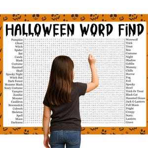 May include: A Halloween word search puzzle with an orange border decorated with jack-o'-lanterns. The puzzle is titled "HALLOWEEN WORD FIND" and features a list of Halloween-themed words. A young person is pointing at the puzzle.