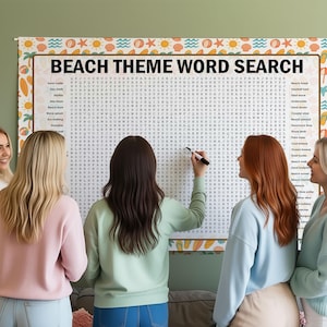 May include: A large "Beach Theme Word Search" puzzle with a decorative border featuring suns, seashells, and waves. Several people are gathered around the puzzle, with one person using a marker to circle words. The puzzle is on a wall.