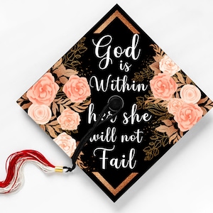 May include: Black graduation cap with a gold and peach floral design. The text "God is Within her she will not Fail" is printed in white on the cap.
