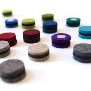 May include: Assortment of felt circles in various colors, including red, green, blue, purple, and gray. Each circle has a black band around the edge.