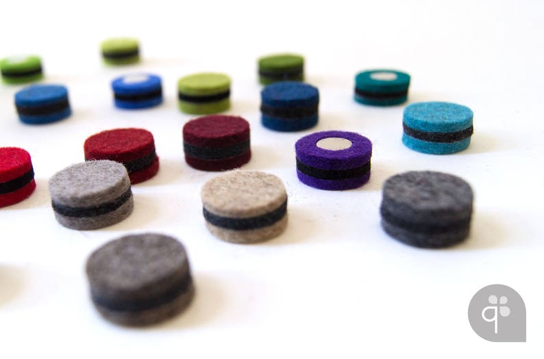 May include: Assortment of felt circles in various colors, including red, green, blue, purple, and gray. Each circle has a black band around the edge.