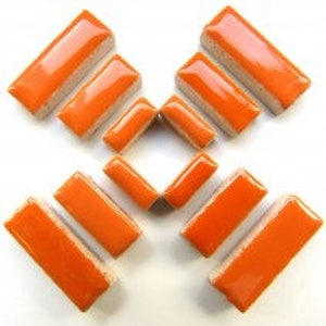 May include: Ten orange ceramic tiles in a rectangular shape. The tiles are arranged in a cross pattern.