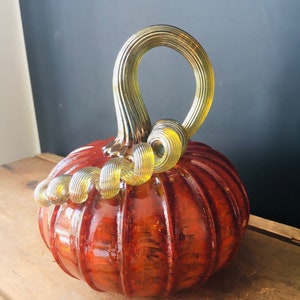 Burnt red hand blown glass pumpkin with iridescent gold stem