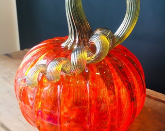 Orange jewel tone hand blown glass pumpkin with iridescent gold stem