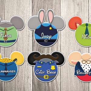 May include: A collection of six character-themed stickers, each designed in a Mickey Mouse ear shape. The stickers feature characters like Flash, Judy, Nick, Clawhauser, Chief Bogo, and Bellwether, with their names displayed.